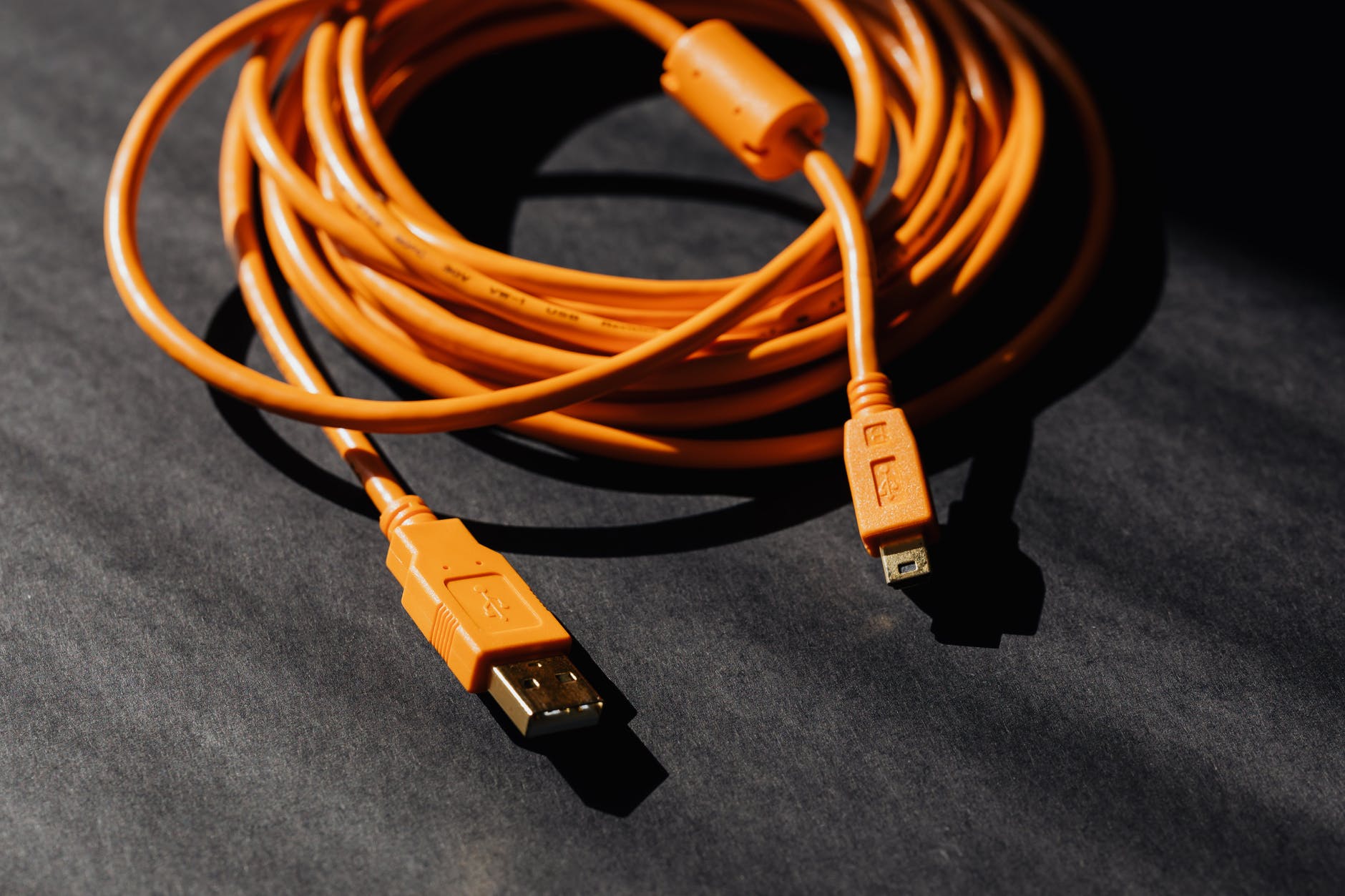 orange usb charger cable on black surface